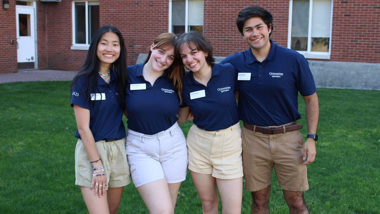 Christina Stoeffler standing in an orientation leader uniform with other students.