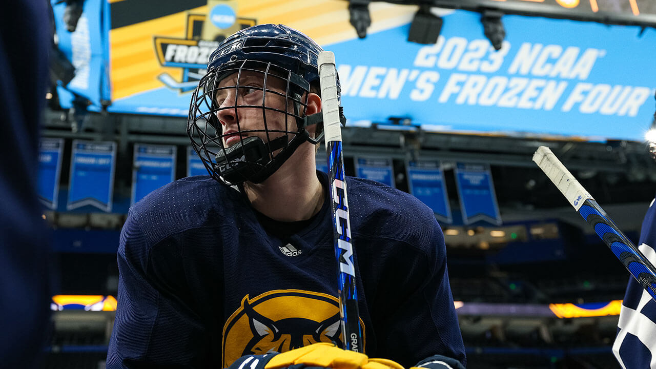 A men's ice hockey player on the ice at the Frozen Four.