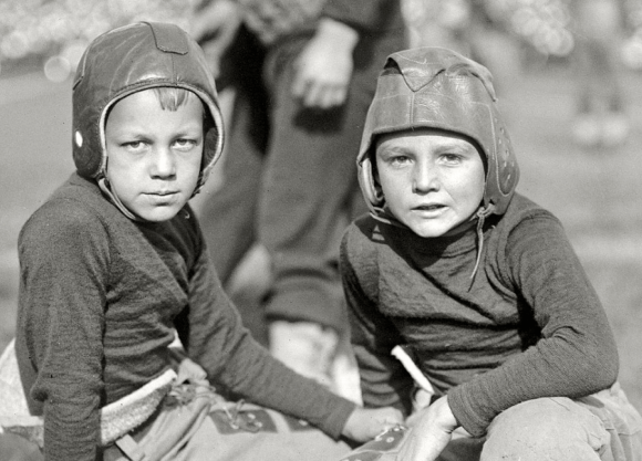 two boys wear football gear 1922
