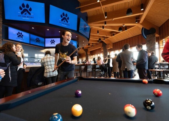 Student plays pool at pub