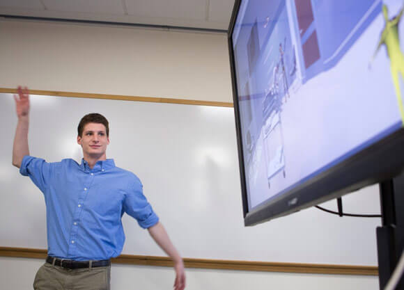 Mike Smizaski '17, a biomedical science major, demonstrates his work during an interprofessional event at the Center for Medicine, Nursing and Health Sciences on our North Haven Campus