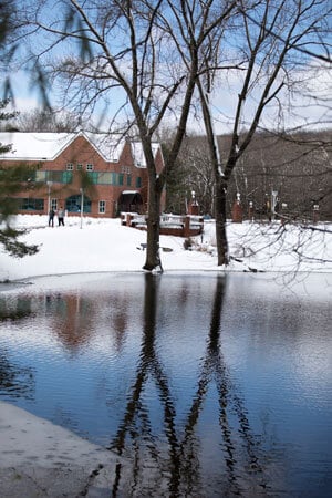 Snow blankets the campus surrounding the pond on the Mount Carmel Campus.