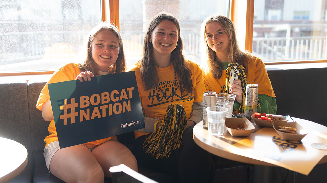 A group of students hang out at On the Rocks during a hockey watch party