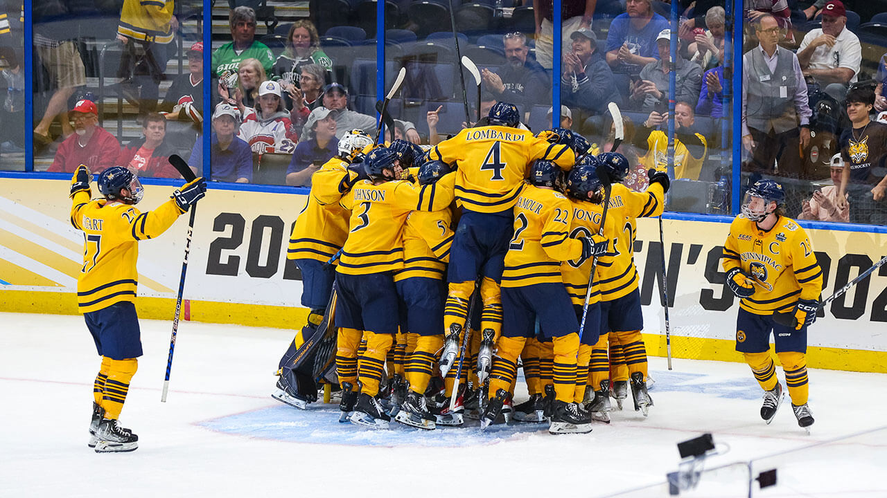 Men's ice hockey team celebrates beating Michigan.