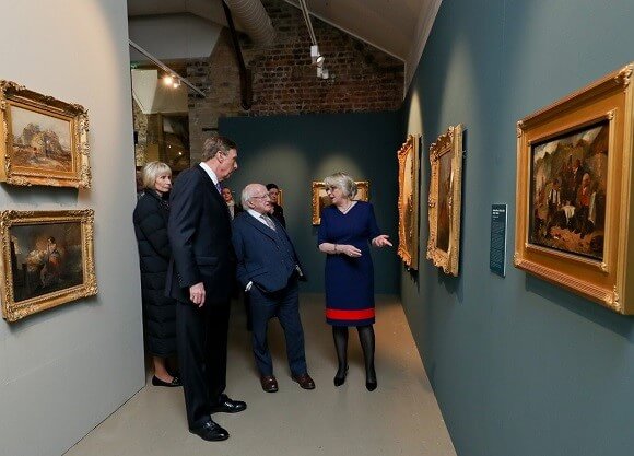 Higgins, Lahey and O'Sullivan walk among a gallery of paintings.