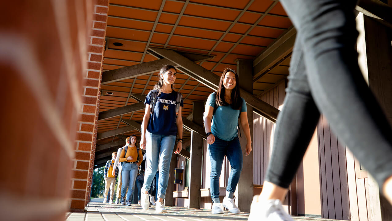 Students walk between classes outside of the College of Arts and Sciences.