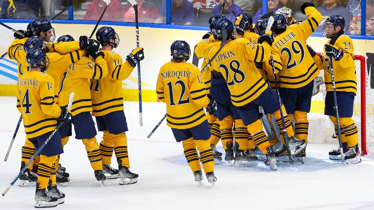 The men's ice hockey team celebrates their semifinal win during the Frozen Four