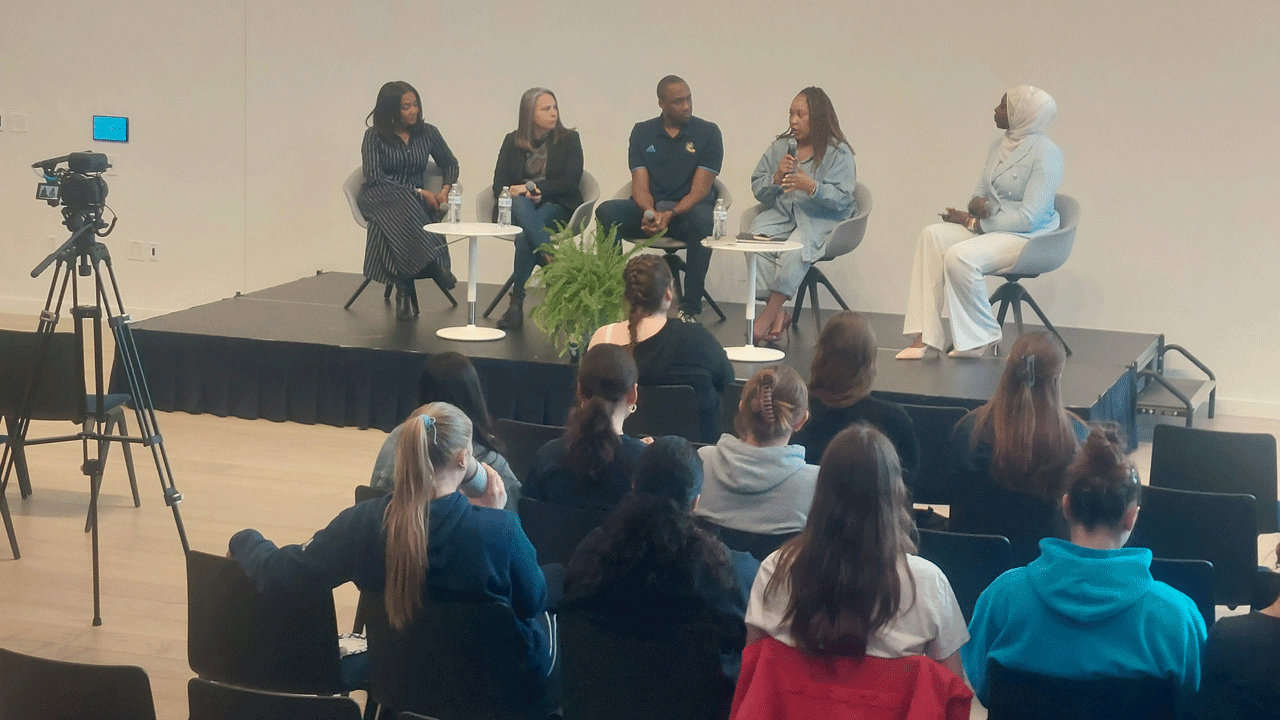Panelists sitting in front of a crowd