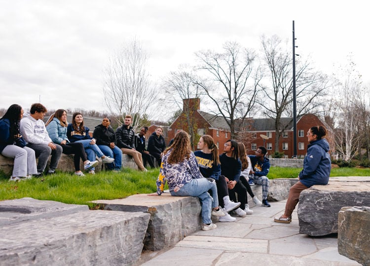 Students participate in a mental health session in the campus ampitheater.