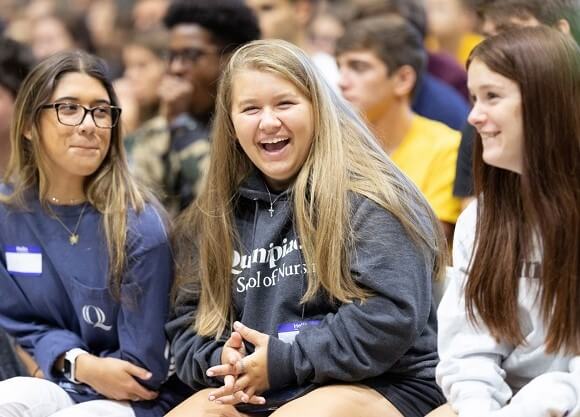 Students smile during the Welcome Weekend remarks.