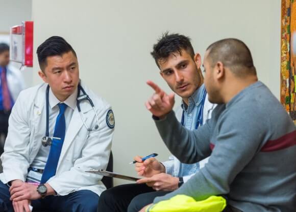 Quinnipiac students with a patient at the Bobcat Community Clinic at Quinnipiac University