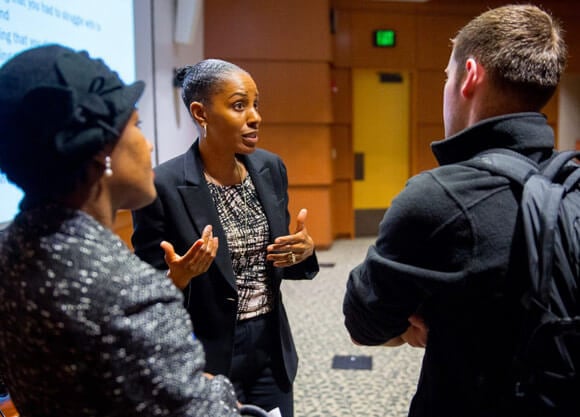 Kenya Beard, a nationally leading research in race, implicitly bias and health care disparities, talks with a student