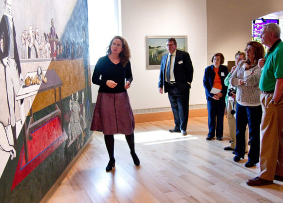 Grace Brady, left, executive director of Ireland’s Great Hunger Museum at Quinnipiac University, leads a museum tour.