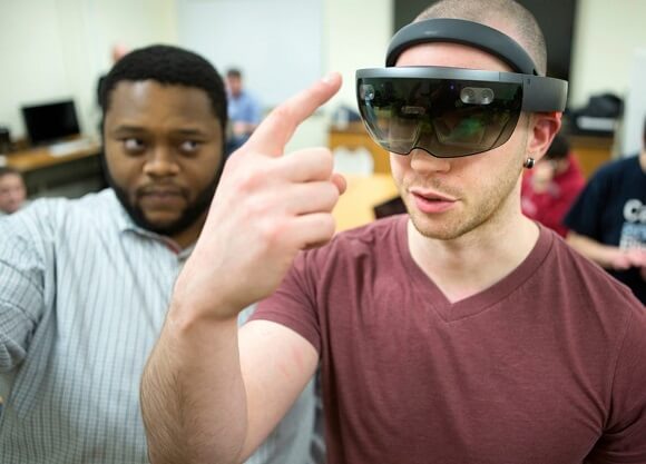 Ron Burgess, a '15 alum and game designer at SphereGen in New Haven, shows Brian Young, a 3D modeler from Bristol, a virtual reality tool during the Global Game Jam, an annual event where game developers around the world collaborate and build games within a 48-hour time period, Friday, Jan. 20, 2017 in Quinnipiac's Game Design and Development Lab on the Mount Carmel Campus.