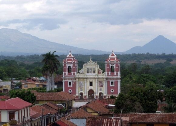 A view of the Calvario Church, and volcanoes in the distance, from the center of Leon, Nicaragua
