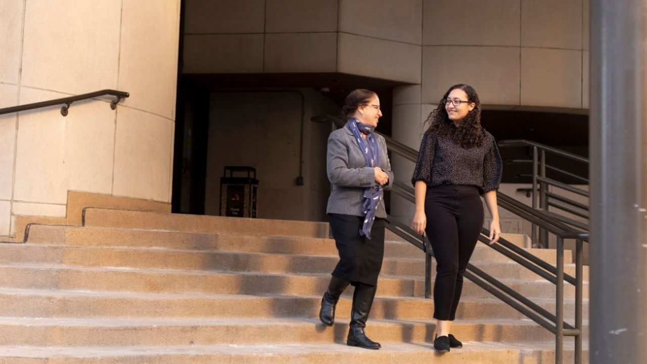 Kayla Stephen walks down the stairs with another woman at the New Haven court house.