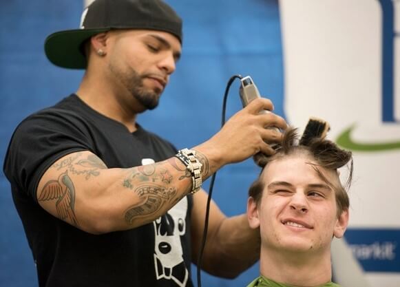 Sophomore Ben Mahon has his head shaved during the annual Quinnipiac University St. Baldrick's event
