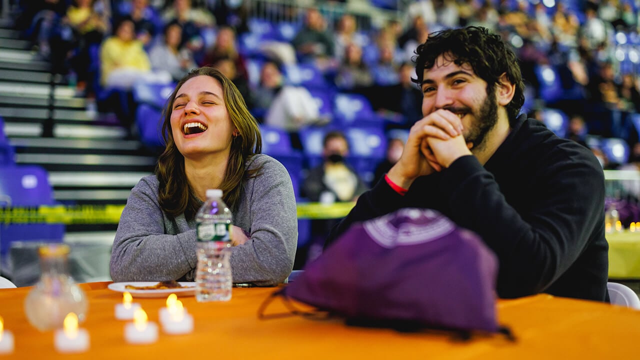 Students laugh during the comedy show.