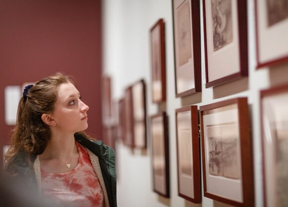 Girl stares at art in museum