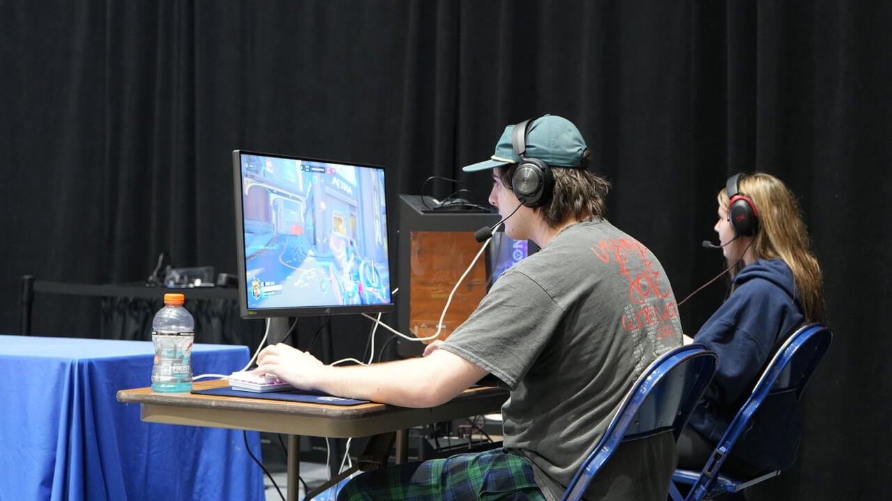 Two Esports members play alongside each other