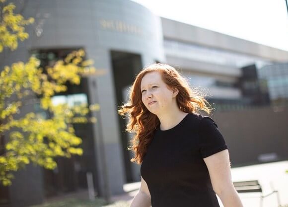 Nicole Dwyer walks outside the entrance to the School of Law.