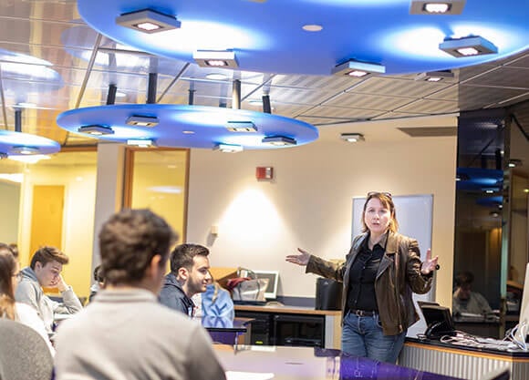professor giving lecture to room of students