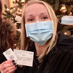 Jordan Weiss with her vaccination card