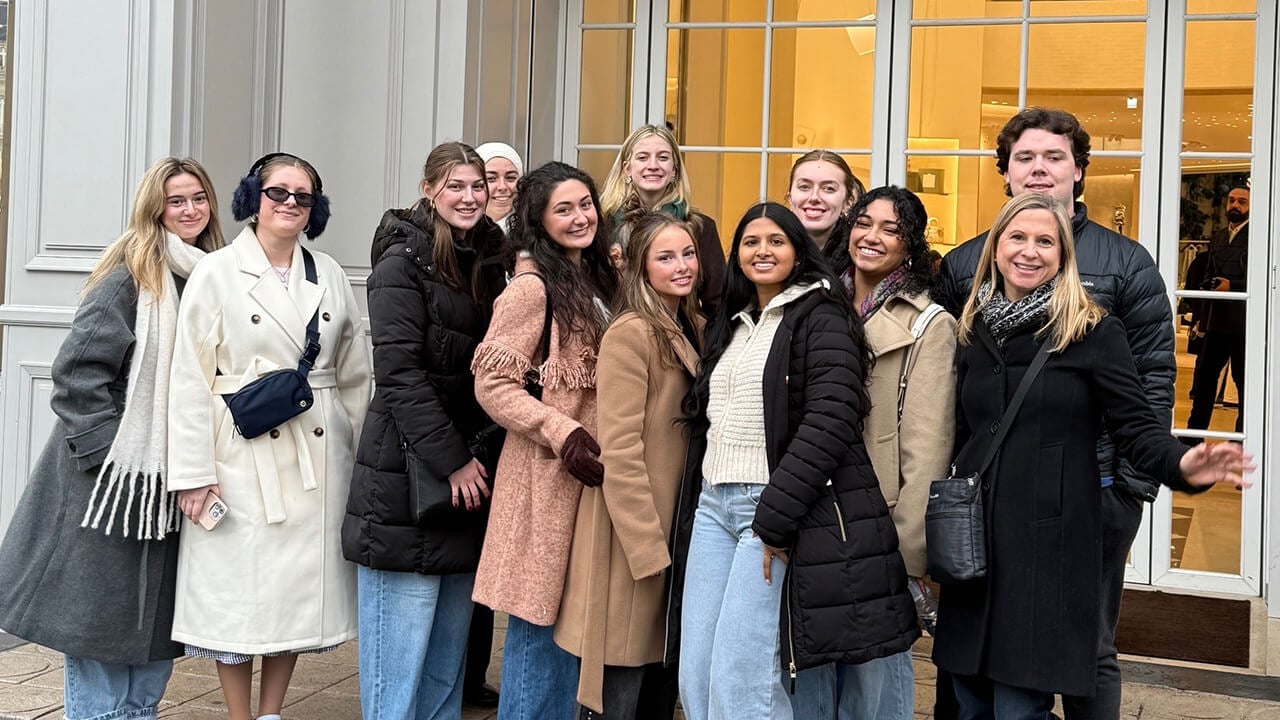 Group photo of study abroad group outside a Dior store