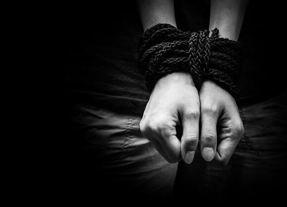 Black and white photo of bound hands