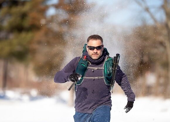 Lee-Stuart Evans runs outside through the snow.