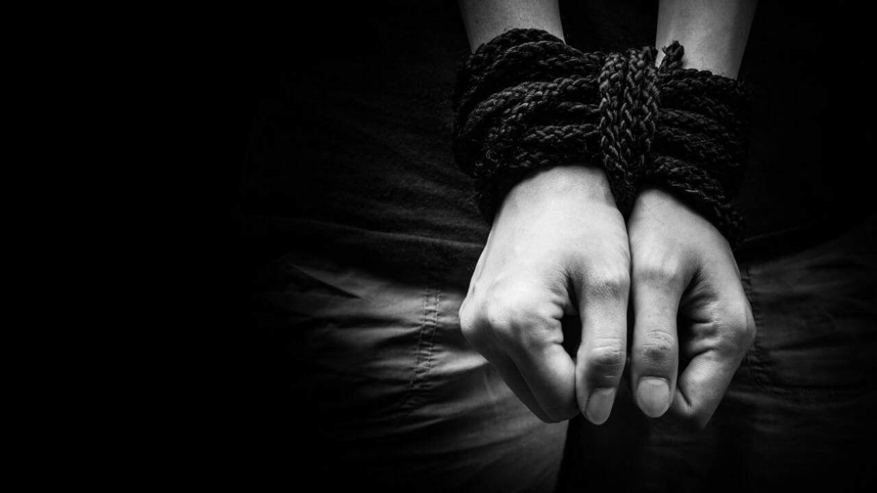 Black and white photo of bound hands
