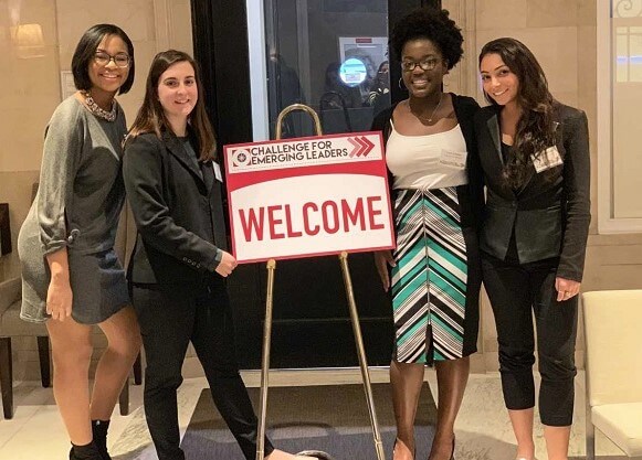 Chelsea Jones, Catherine Fabiano, Luna Charles and Deanna DiRienzo pose for a photo together with a sign for the Challenge for Emerging Leader workshop