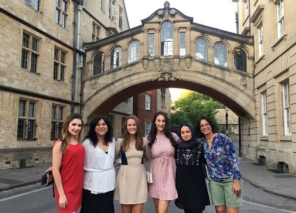 Quinnipiac students and professor stand together at Oxford under the Bridge of Sighs