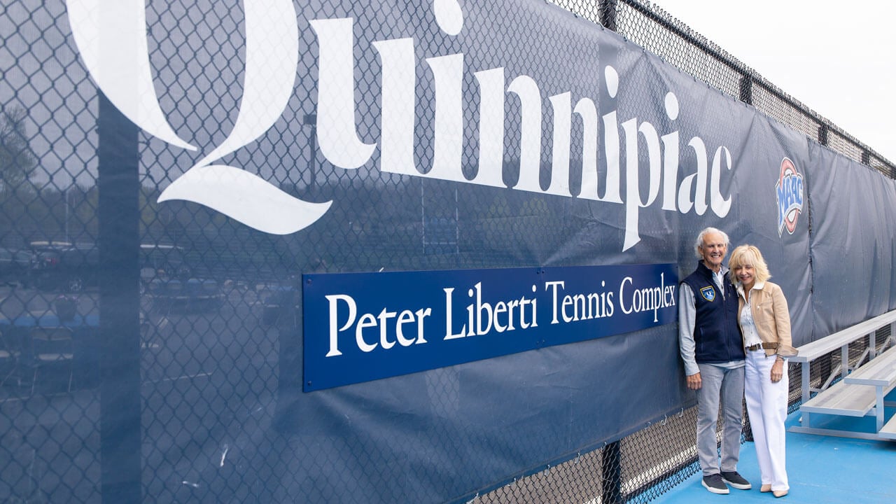 Judy Olian and Peter Liberti smiling in front of the tennis complex