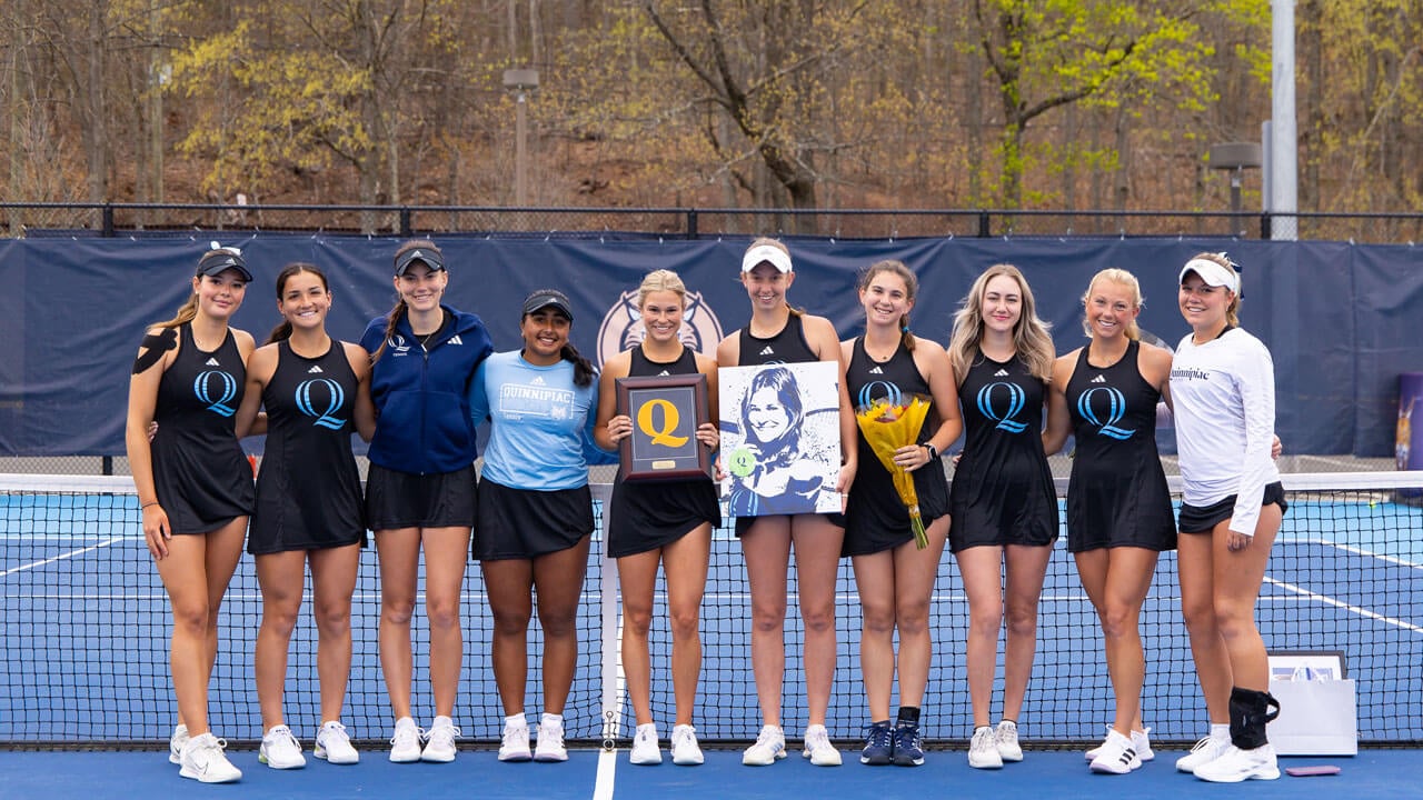 Student athletes smile together on the Peter Liberti Tennis Complex