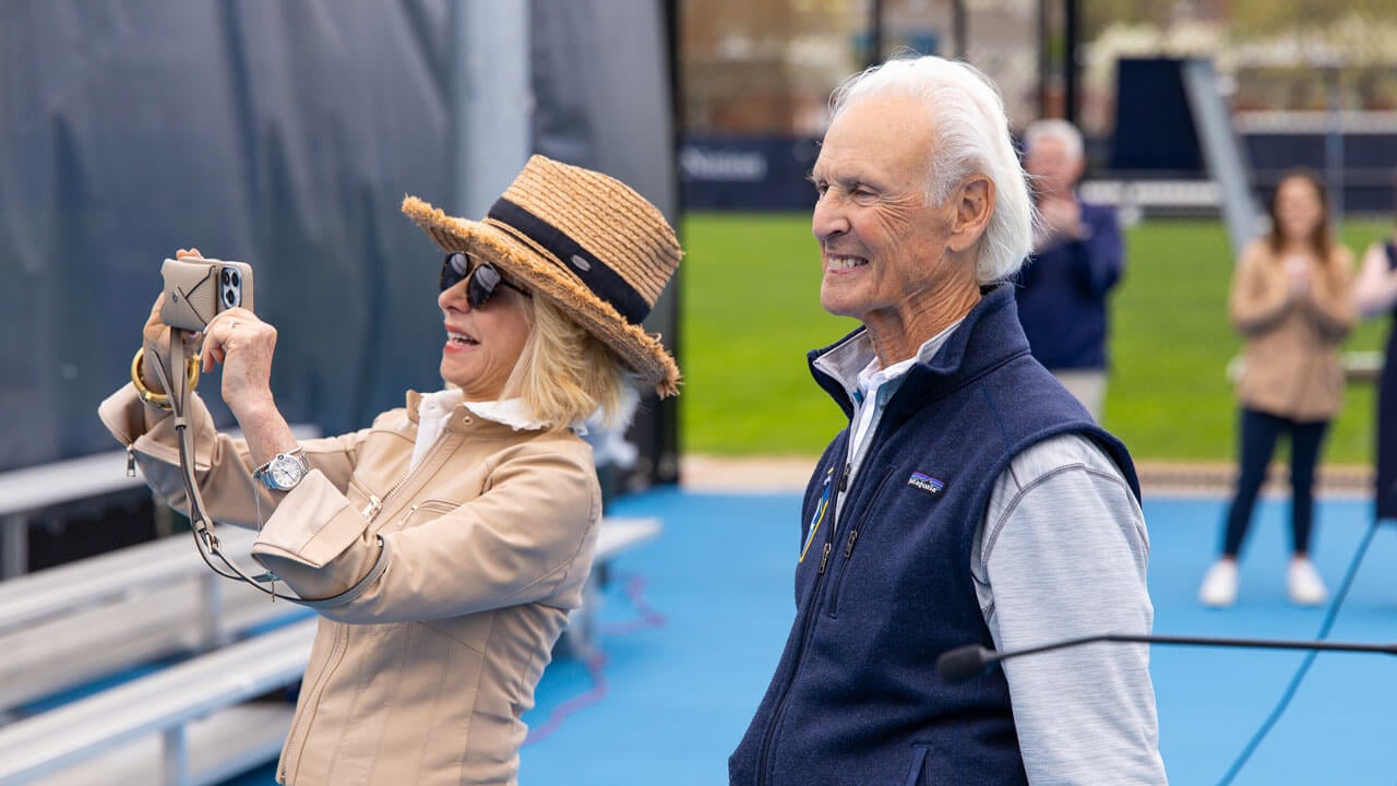 Judy Olian taking a photo with Peter Liberti