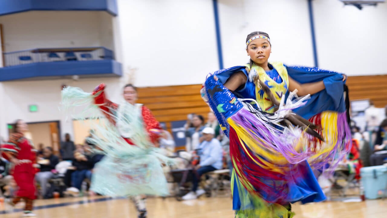 Performers dance in traditional regalia at the Dancing in the Shadow of Sleeping Giant Powwow held at Quinnipiac