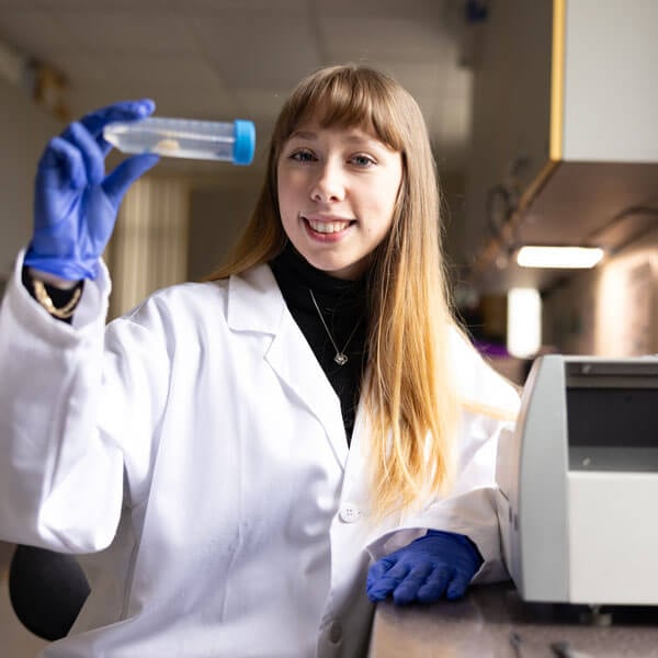 Tressa Pantaela holding a lab vial