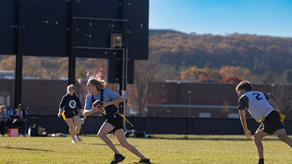 Student participating in intramural flag football