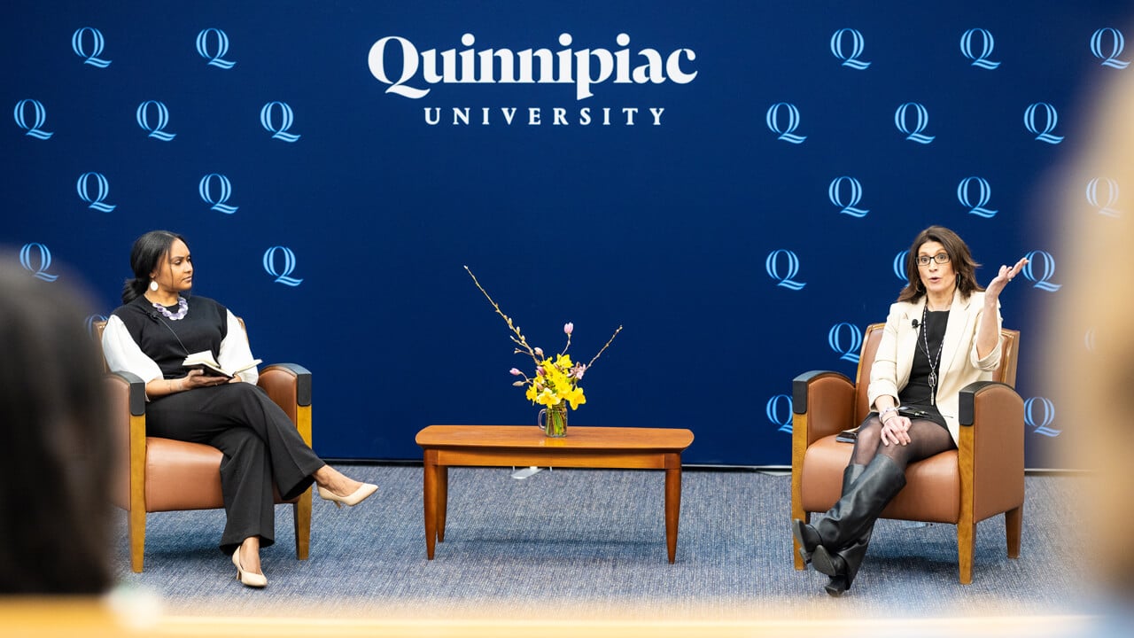 Sarah Harris and Jennifer Rawlings having a conversation while seated in comfy chairs