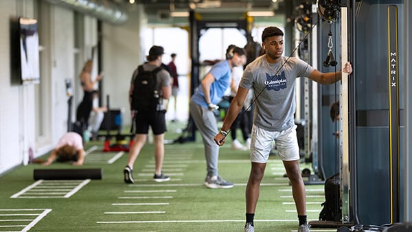 Students use RecWell equipment during workout