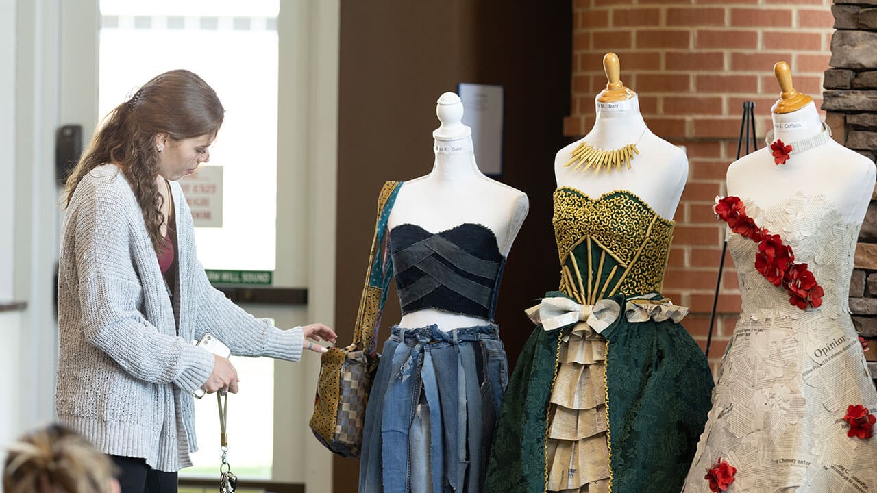 Students present the dresses they made from recycled items
