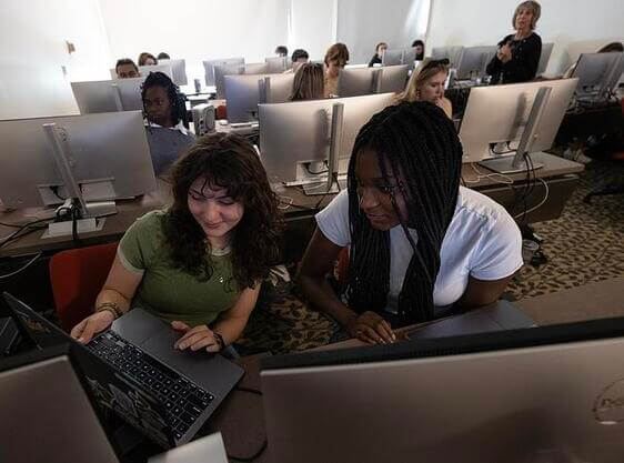 Two female students working in a computer lab