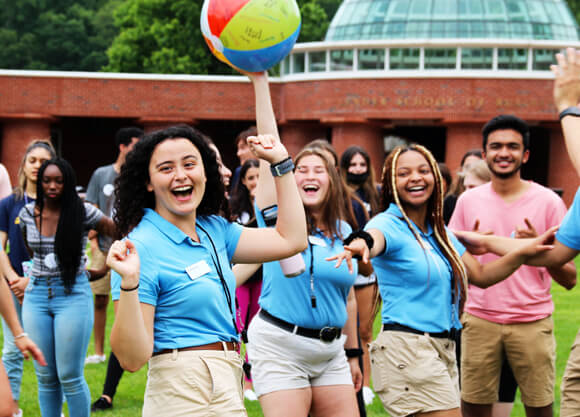 Orientation leaders cheer during a game on the quad