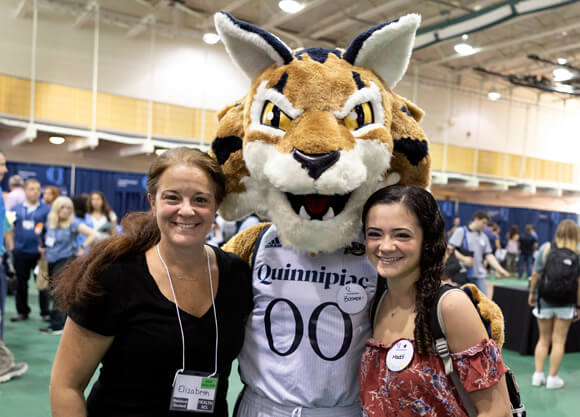 A new student and her mom pose for a photo with Boomer the mascot