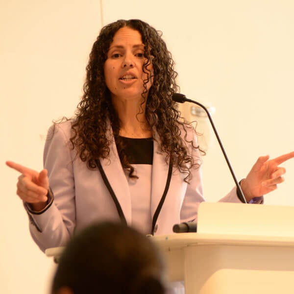 Ines Zemaitis speaks at a podium with a microphone