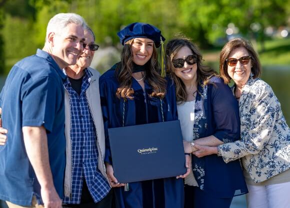 A family celebrates Commencement with their graduate