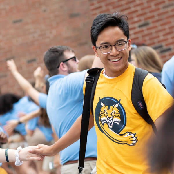 A student in a gold Bobcat shirt participates in an Orientation activity