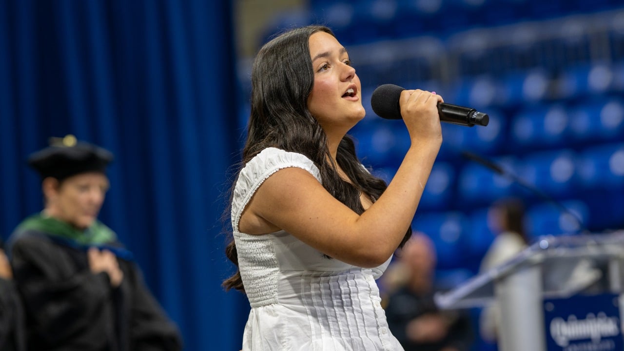 Addison Prunier sings the National Anthem at commencement