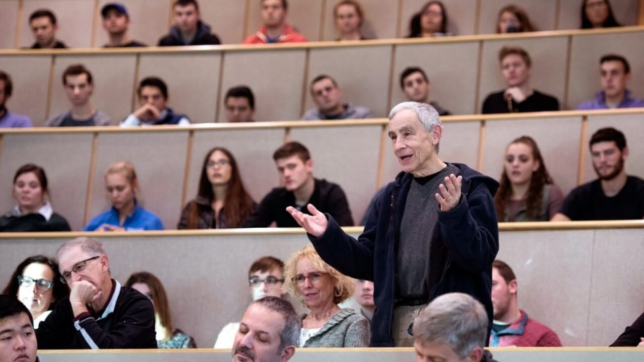 Rothman speaks in a lecture hall.